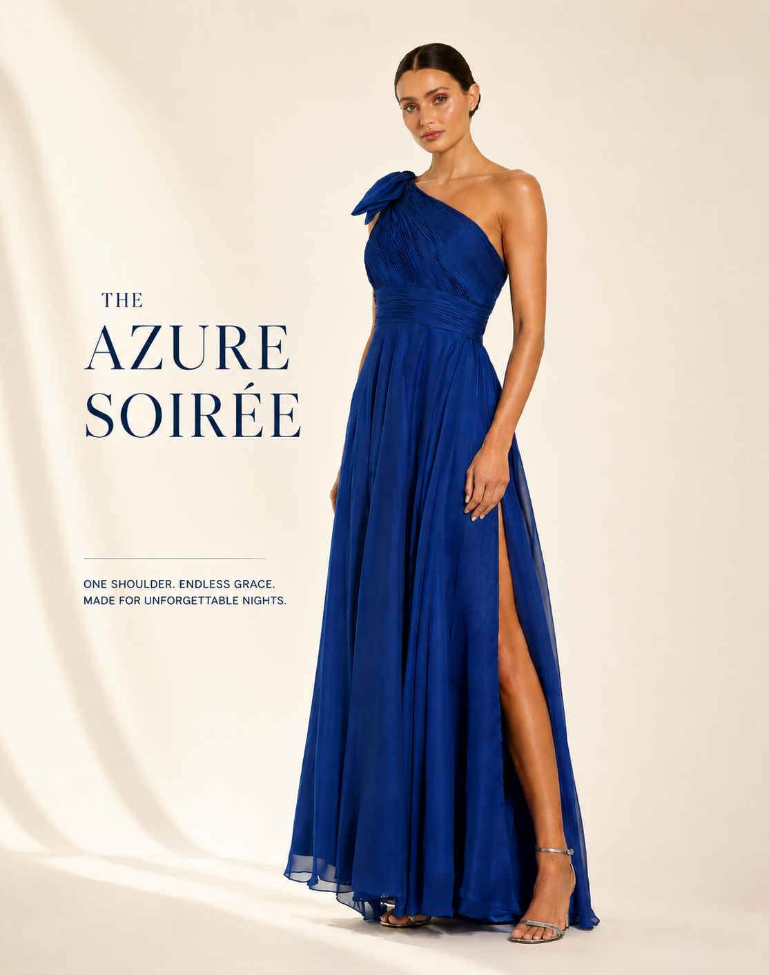 A woman models a floor-length one-shoulder evening gown in a rich royal blue, styled with clear high-heeled sandals against a warm cream studio backdrop. royal blue evening gown Australia